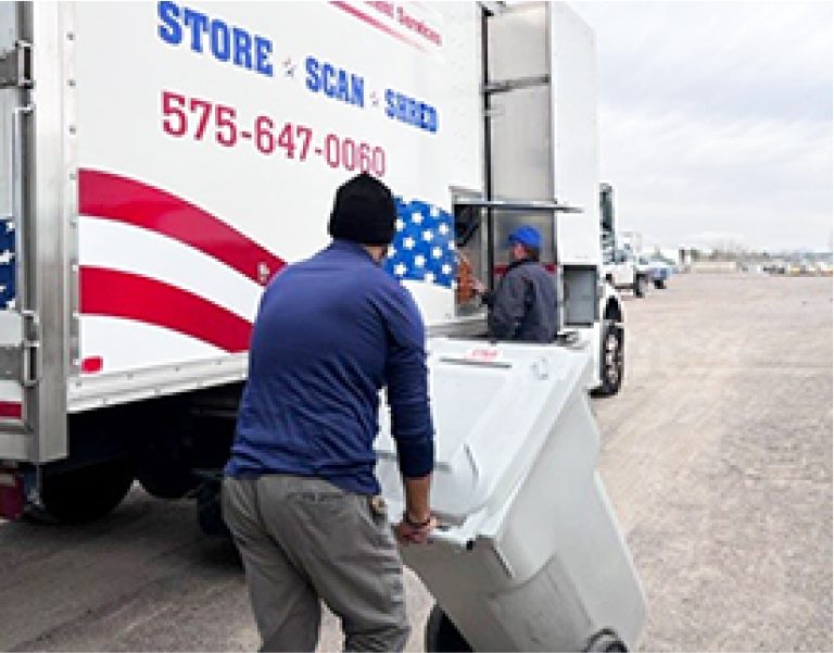 Employees loading documents for shredding